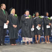 <p>Bassick High staff members say the Pledge of Allegiance on stage.</p>
