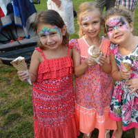 <p>Young ladies enjoy their icecream after getting their faces painted at Shelton Sounds.</p>
