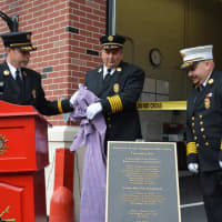 <p>A plaque showing the participants in the new firehouse effort is unveiled.</p>