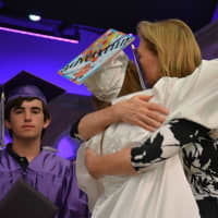 <p>Former Katonah-Lewisboro school board Trustee Janet Harckham hugs her daughter, Katherine, after presenting her with a diploma at John Jay High School&#x27;s 2016 commencement.</p>