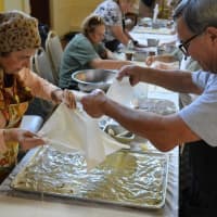 <p>The baking committee at St. Anthony&#x27;s Church in Bergenfield making baklava layer by painstaking layer. Pair in the foreground is Genny Mandalakis of Fort Lee, left, and John Ziemba of Old Tappan.</p>