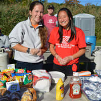 <p>Volunteers from the Boys &amp; Girls Club dish up hamburgers, hotdogs and all the fixings at the Ridgefield Carnival.</p>
