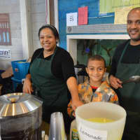 <p>These vendors recruit a young helper to keep the lines moving at the Chocolate Expo.</p>