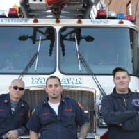 <p>Fair Lawn Volnteer Firefighters take a break from playing with adoptable pups.</p>