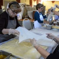 <p>Making baklava, step one: Alice Ziemba of Old Tappan and Lois Dedes of Paramus add a layer of filo dough.</p>