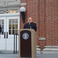 <p>Msgr. William Sheyd leads the crowd in a prayer at New Canaan&#x27;s Sept. 11 ceremony.</p>