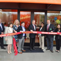 <p>Natasha LaDew, owner of Kidville, cuts the ribbon in front of her new Closter Plaza location.</p>