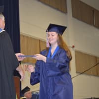 <p>Handing out the diplomas at the New Fairfield High graduation</p>