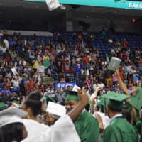 <p>The graduates throw up their caps in celebration as the Bassick High commencement wraps up.</p>