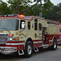 <p>A Mount Kisco firetruck is driven in the fire department&#x27;s annual parade. The truck is for the Independent Fire Company, which is one of four companies that operates as part of the department.</p>
