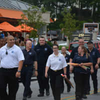 <p>Members of the Mount Kisco Volunteer Ambulance Corps march in the fire department&#x27;s parade.</p>