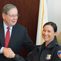 <p>Mayor David Martin shakes hands with Officer Nicole Petrenko, who found the suspects&#x27; getaway car while on patrol. </p>