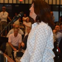 <p>Corinne Vizzo, former sister-in-law of Mayor Joe Ganim, speaks at an impromptu tax forum in Bridgeport.</p>
