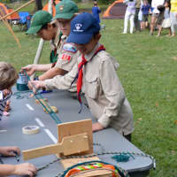 <p>Community members got to try their hand at rope-making in a demonstration led by Darien Boy Scouts</p>