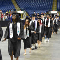 <p>The Class of 2016 from Fairchild Wheeler High marches into the Webster Bank Arena.</p>