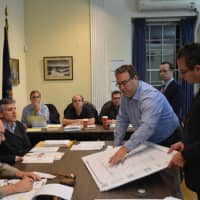 <p>Architect Christopher Raffaelli (center), discusses the revised Modell&#x27;s proposal at a Mount Kisco Planning Board meeting.</p>