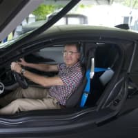 <p>A visitor checks out one of the high-end BMWs at the show.</p>