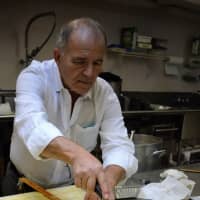 <p>Making baklava, step three: Nick Dedes, parishioner and owner of Echo Tap &amp; Grille in Mountainside, measures and cuts.</p>