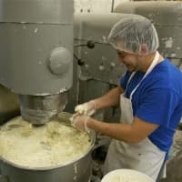 <p>Preparing batter for the cakes at Carousel Cakes.</p>