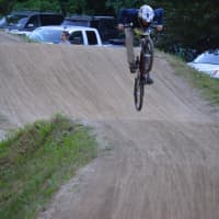 <p>A rider flies on the track at Bethel BMX for Olympic Day.</p>