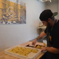<p>Thomas Tenaglia packages fresh pasta at Grana Pastificio in Westport.</p>
