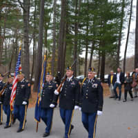<p>A color guard leads a procession from the grounds of the Pound Ridge Town House to Route 137, where signage has been posted naming the road in honor of Eric Jones.</p>