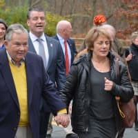 <p>Eric Jones&#x27; parents, Ken and Cindy, march in a procession towards signage along Route 137 in Pound Ridge. The signage notes honorary naming of the road after Jones.</p>