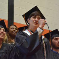 <p>A member of Pawling High School&#x27;s Class of 2016 performs a solo as part of a rendition of Paul Simon&#x27;s &quot;Bridge Over Troubled Water&quot; at the commencement.</p>