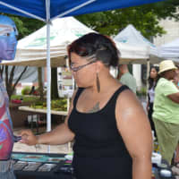 <p>Alicia Cobb, of Stratford, demonstrates her body painting technique at the downtown farmers market in Bridgeport.</p>