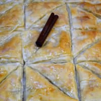 <p>Baklava cooling. The baking team at St. Anthony&#x27;s puts a cinnamon stick on the pistachio baklawas to distinguish them from the walnut baklavas.</p>