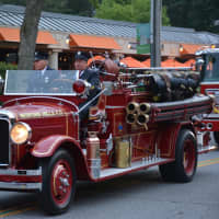 <p>An antique Bedford Hills firetruck is driven in the Mount Kisco Fire Department&#x27;s annual parade.</p>