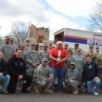 <p>Former Closter Police Sgt. Don Nicoletti, bottom row, second from left, military members from the Teaneck Armory and friends break from sorting and loading.</p>