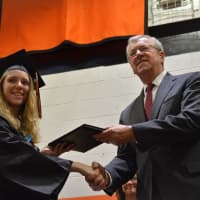 <p>A newly minted Pawling High School graduate receives her diploma at the 2016 commencement.</p>