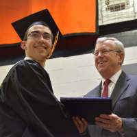 <p>A newly minted Pawling High School graduate receives his diploma at the 2016 commencement.</p>