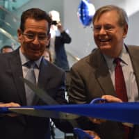 <p>Gov. Dannel Malloy attends the ribbon cutting for the new Conair facility in Stamford on Monday with Mayor David Martin and Conair founder Lee Rizzuto Jr.</p>