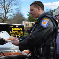 <p>Johnny Meatballs feeds a member of the Paramus Police Motorcycle Unit.</p>