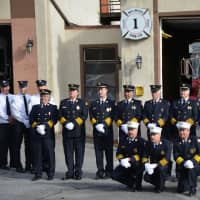 <p>Millwood firefighters pose for pictures in front of their old Station No. 1, which is being decommissioned after more than 90 years of service.</p>