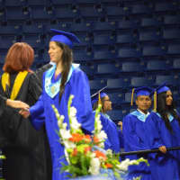 <p>Graduates proceed across the stage one by one at the Harding High graduation.</p>