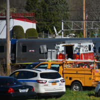 <p>Investigators are at the scene of a grade crossing in Bedford Hills. A train collided with a vehicle at the crossing on Wednesday.</p>
