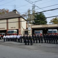 <p>Millwood firefighters pose for pictures in front of their old Station No. 1, which is being decommissioned following more than 90 years of usage.</p>