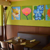 <p>Basso Café Restaurant and Bar in Norwalk has bright walls adorned with large canvas paintings. The dining room seats 60 diners. </p>