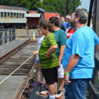 <p>Family and friends stand on top of an actual turntable in the railroad yard.</p>
