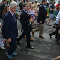 <p>Former President Bill Clinton marches in the town of New Castle&#x27;s 2016 Memorial Day parade, held in downtown Chappaqua. State Assemblyman David Buchwald, pictured at right, marches with his infant daughter.</p>