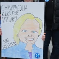 <p>A Hillary Clinton supporter displays a homemade fan poster of the Democratic presidential candidate. A large group of supporters gathered in Chappaqua for Clinton&#x27;s arrival at her polling place.</p>