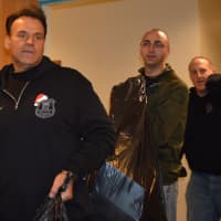 <p>Former Closter Police Sgt. Don Nicoletti leads Harrington Park Officer Jacob Miller and Oradell Officer Rich Liguori into the gift-holding room at HUMC.</p>