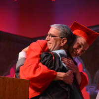 <p>Jesse Hoogland, Fox Lane High School&#x27;s 2016 salutatorian, hugs outgoing Principal Joel Adelberg, who is taking a new role in Bedford Central by becoming an assistant superintendent.</p>
