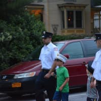 <p>Harrison firefighters, with kids by their sides, march in the Mount Kisco Fire Department&#x27;s parade.</p>
