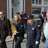 <p>Millwood Fire Commissioners march in a procession through downtown from the old firehouse to the new one.</p>