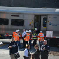 <p>Investigators from the MTA Police gather at the scene of a grade crossing collision in Bedford Hills.</p>