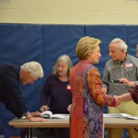 <p>Hillary Clinton chats with an election worker at Chappaqua&#x27;s Douglas G. Grafflin Elementary School. The building serves as Clinton&#x27;s polling place for the Democratic presidential primary. Former President Bill Clinton is pictured checking in.</p>